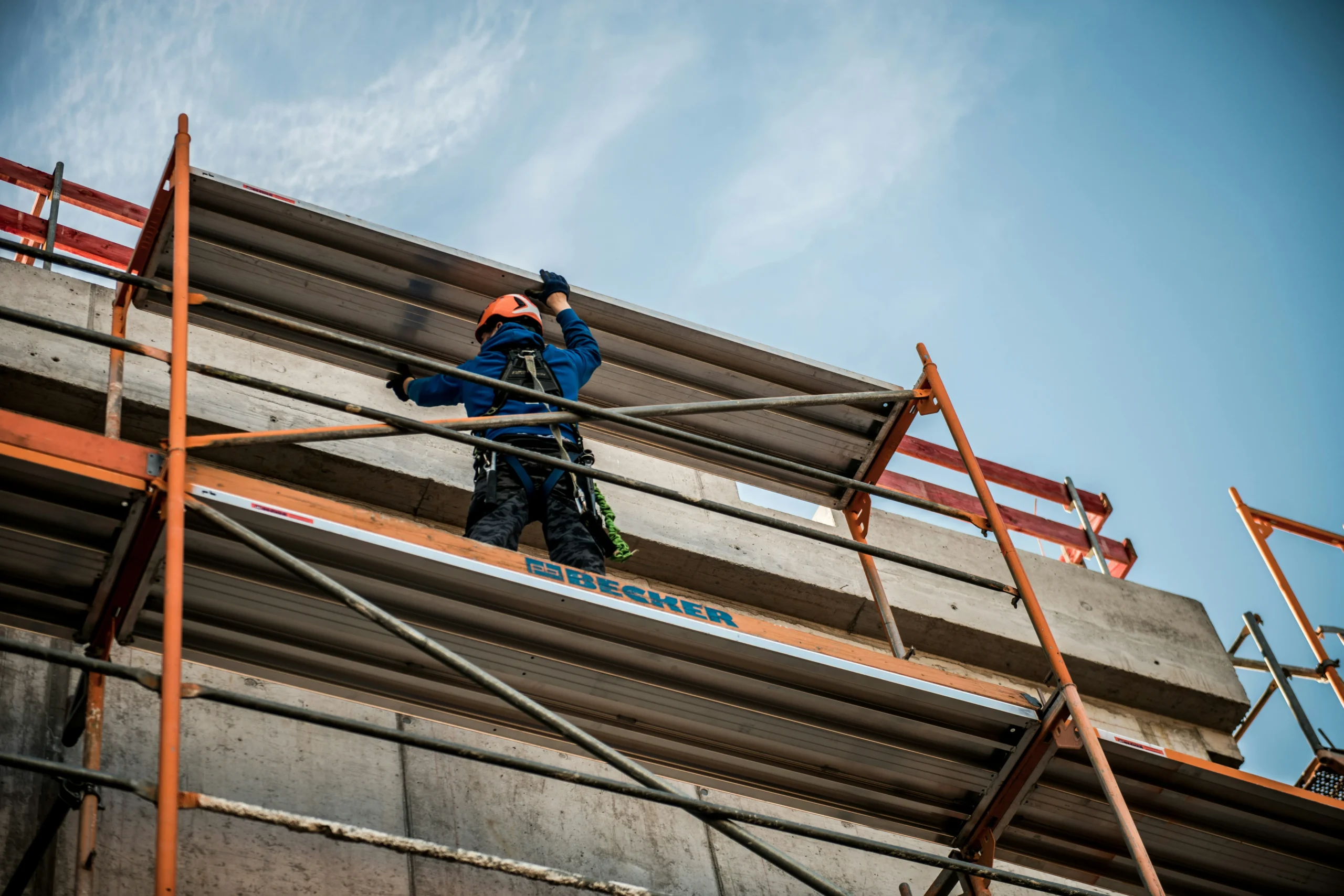 A man high up on scaffolding